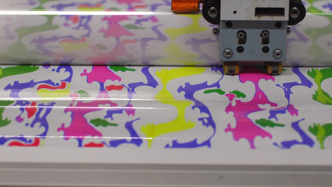 DTF printer printing a colorful pattern on transfer film